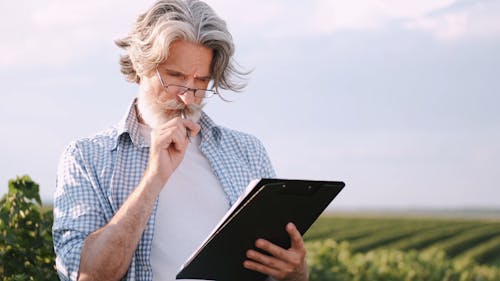 Man Thinking Deeply while Looking at Papers