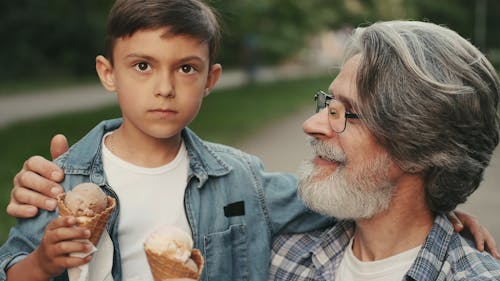 A Grandfather and a Grandson Putting an Ice Cream on Each Other's Nose