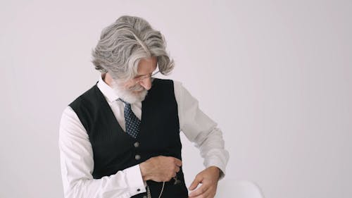 An Old Man Looking At His Pocket Watch
