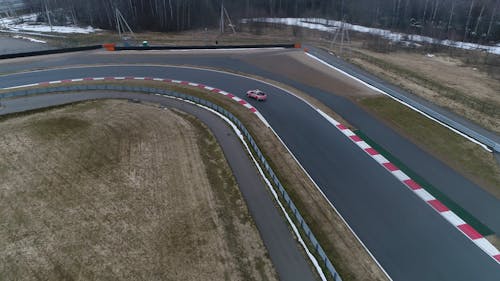 Aerial View of Police Pickup Van Running on a Racing Circuit