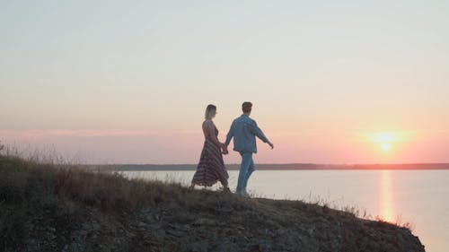 A Couple Walking Towards the Cliff