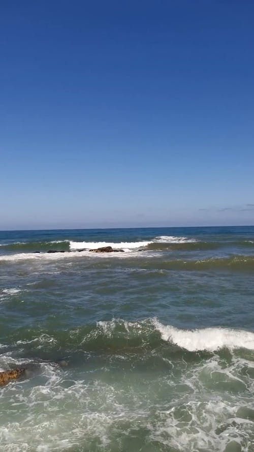 Foamy Sea Waves Rolling to the Sea Shore