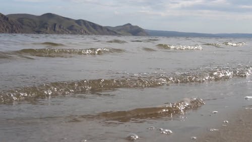 Bubbly Ocean Waves Coming to the Beach Coast