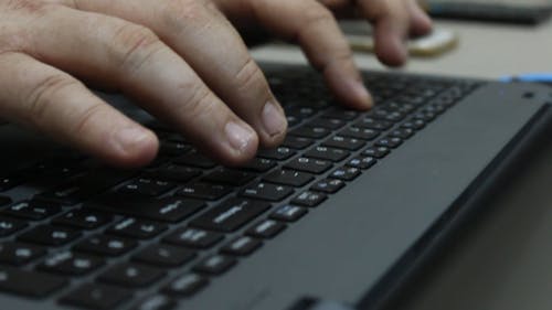 Person Typing on a Laptop