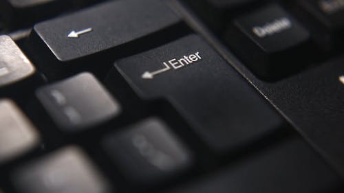 Person Pressing Enter Key of a keyboard
