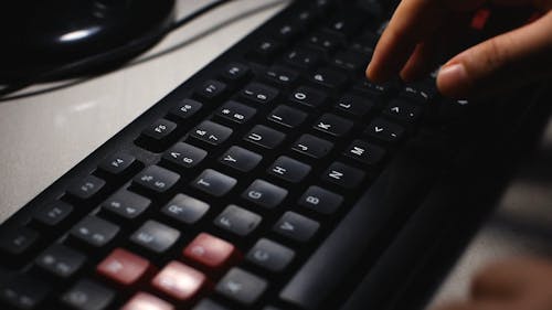 Side View of a Person Typing on Computer