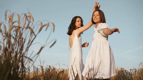 Women in White Dresses Dancing in Paddy Farm