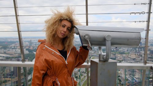 Curly Haired Woman Posing with Tower Viewer