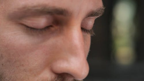 Close up of a Man Slowly Opening his Eyes
