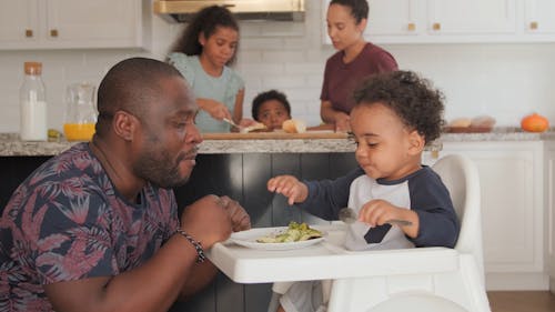 Baby Giving a Slice of his Meal to Father