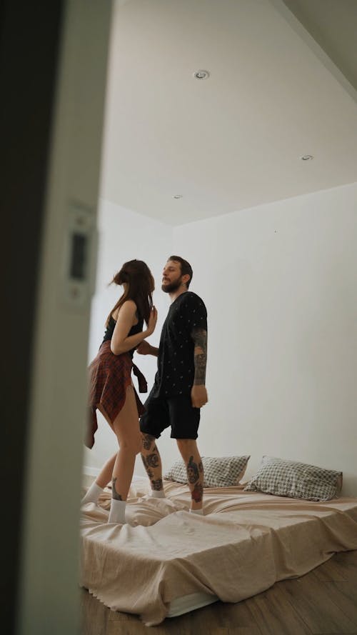 Couple Dancing on Bed