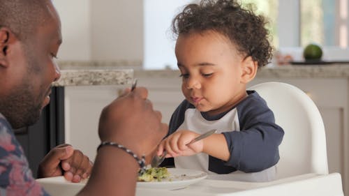 A Father And Child Eating Together