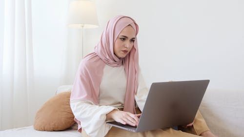 A Woman Busy Working On Her Laptop