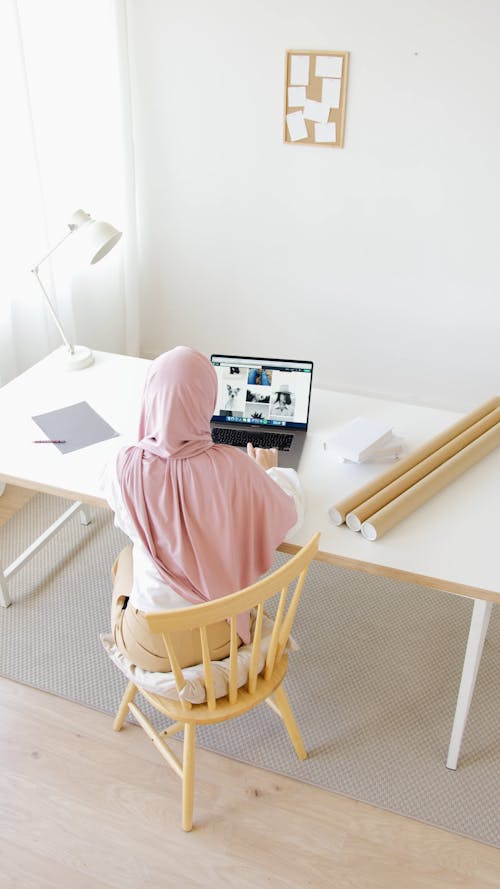 High Angle Shot of Woman in Hijab Using Her Laptop