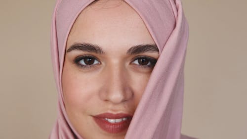 Close-Up View of Woman in Pink Hijab Smiling