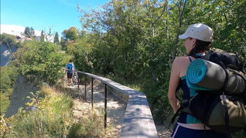 Women Walking though pathway with her Bicycle