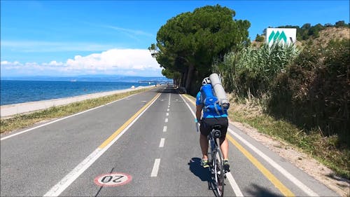 Man Riding a Bike on a Bicycle Lane