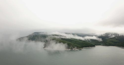 Thick Fog Partially Covering The Mountain Landscape