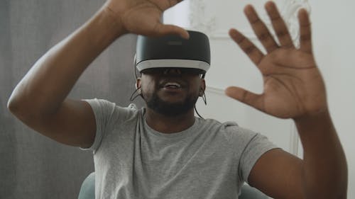 Man with VR Headset Feeling his Surrounding with Hands