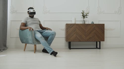 Guy with his VR Headset Looking Around at his Room