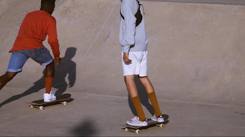 Skateboarders Sliding and Doing Tricks at Skate Park