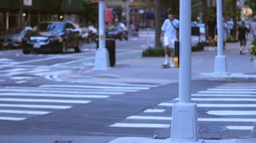 Crossing A Street Riding On A Skateboard