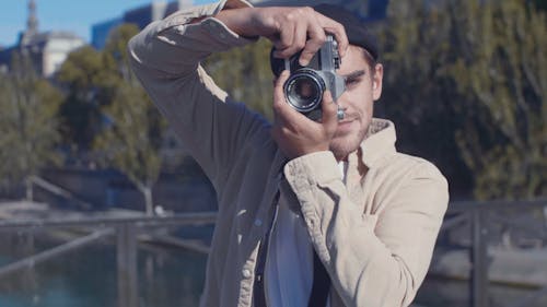 Man Taking Photo Using a Camera