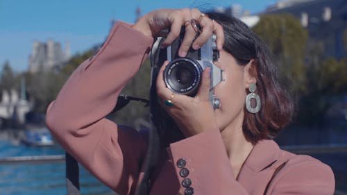 Shallow Focus of Woman Taking Photo Using a Camera