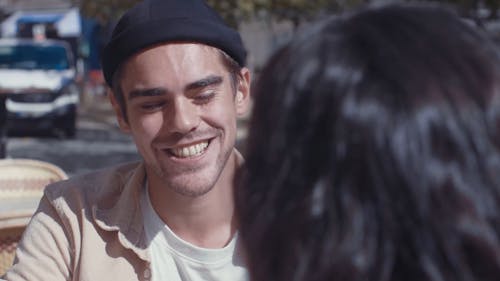 Man Talking to His Girlfriend While Smiling