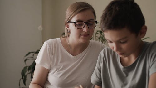 Woman Watching Her Student Writing