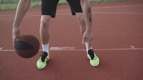 Person Dribbling the Basketball