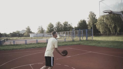 A Man Dunking the Basketball