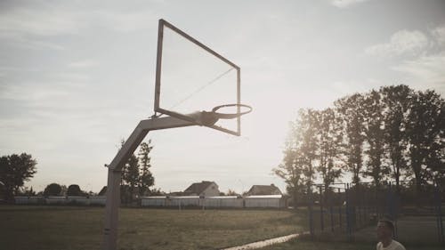 Man Playing Basketball in the Morning