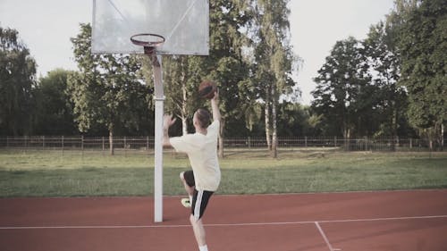 A Man Dunking A Basketball