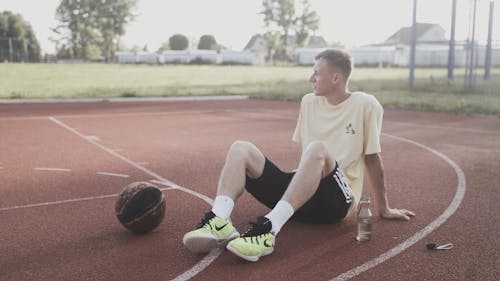 Man Sitting on Basketball Court