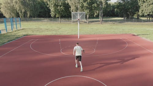 A Man Dunking A Basketball With Two Hands