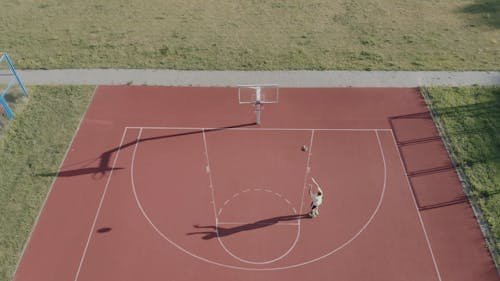 A Man Shooting A Basketball With A Jump Shot