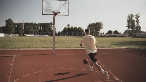 A Man Playing A Game Of Basketball 