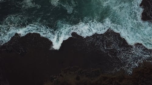 Waves Breaking At The Beach Shore