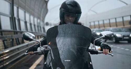 A Woman Riding A Big Motor Bike