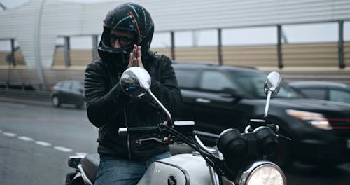 A Bike Rider On A Full Stop On The Road Side