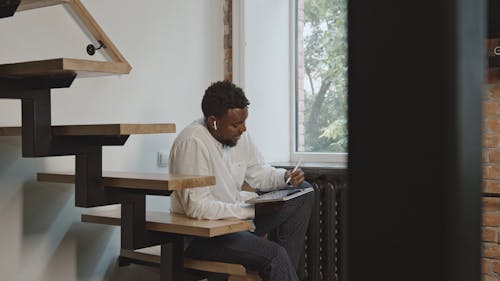 A Man Using An Electronic pad With Stylus Pen