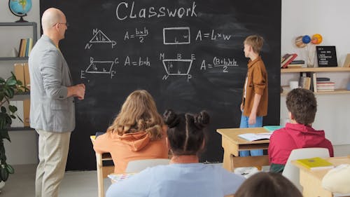 Teacher Explaining Student on Backboard