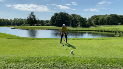 A Golfer Using A Golf Club Driver Foe The Tee Shot