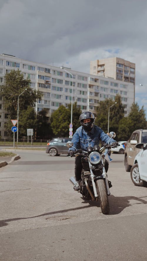 Man in Blue Denim Jacket Driving His Motorcycle