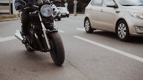 Man Driving His Motorcycle on Road