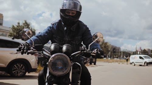 Man in Denim Jacket Riding His Motorcycle