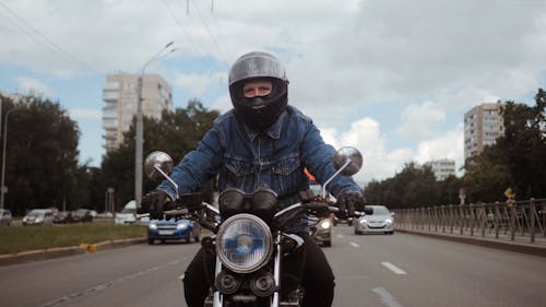 Man in Blue Denim Jacket Riding His Motorcycle