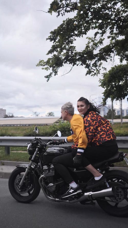 Couple Riding a Black Motorcycle