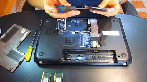 A Man Reparing A Laptop